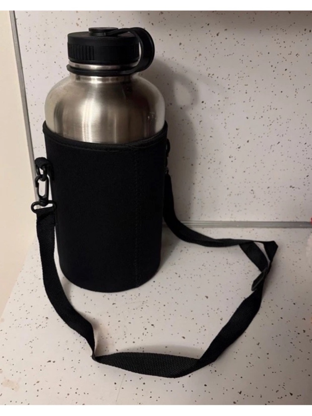 Large Thermos water bottle with black fabric sling carrier